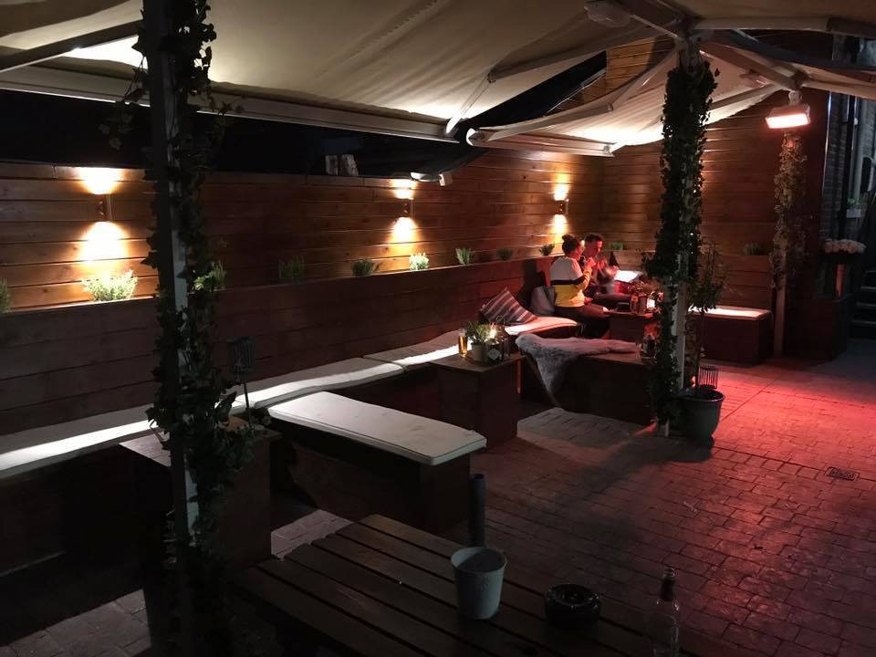 The Summerfield garden at night with lit booths