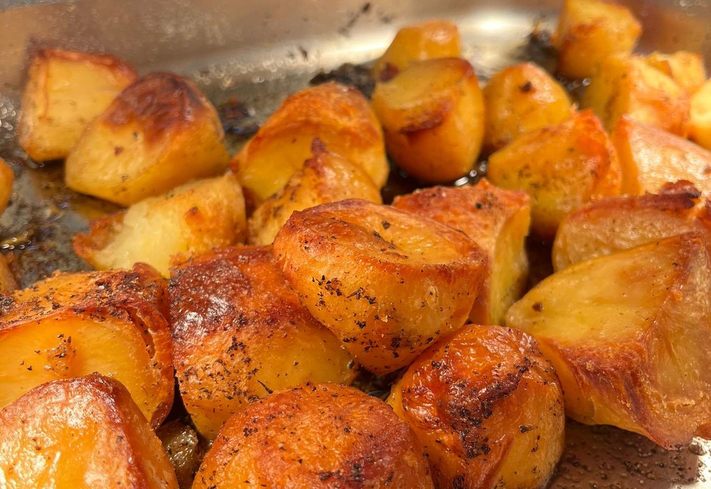 A tray of golden crusty roast potatoes