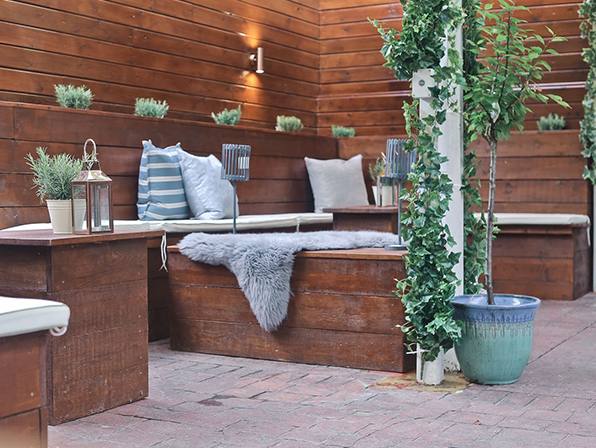 The garden terrace with cushioned benches and plants